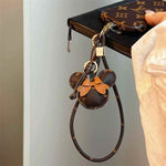 Luxury Monogram Case with Bow Charm & Wrist Lanyard for iPhone 12-18 Pro & Pro Max
