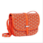Luxury Goyardine canvas saddle crossbody bag in orange
